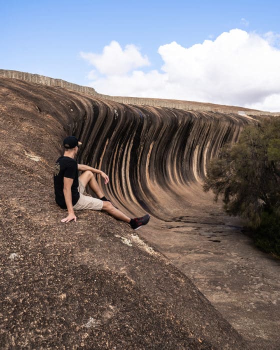 Sitting on the edge of Wave Rock in Hyden, WA